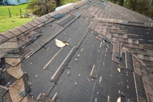 Insulated attic beneath a sloped roof with visible ventilation channels and sunlight across the roof deck.